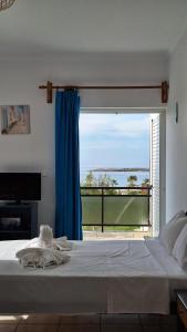 a bedroom with a bed with a view of the ocean at Kalliopi Studios - Apartments in Kato Daratso +98 photos