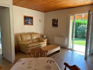 a living room with a couch and a table at Ardèche à Retourtour à 200m de la rivière - pour 7 jours mini in Lamastre