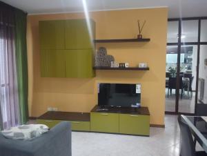 a living room with a tv and a couch at Cozy House in Civitavecchia