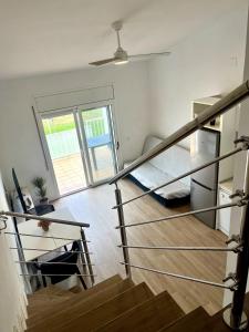 a staircase in a room with a stair case at Apartment with a pool near the beach in Riumar