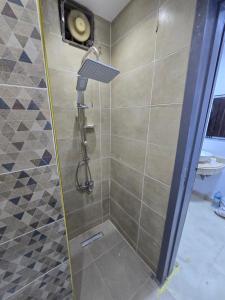 a shower with a shower head in a bathroom at Cozy Private Studio DBL in ‘Ezbet `Abd el-Ḥamîd