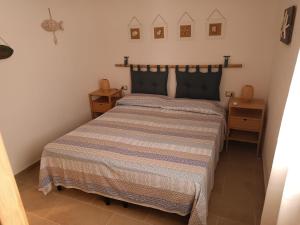 a bedroom with a bed and two night stands at Casa Smeralda Piano terra in Cannigione