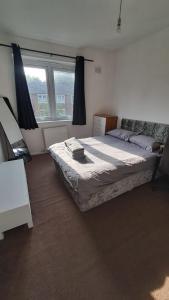 a bedroom with a bed and a large window at Rachel's house in Manchester