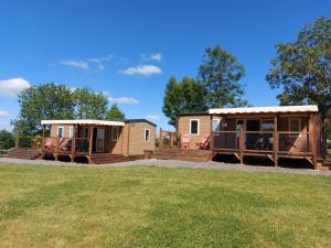 a couple of mobile homes on a lawn at Les Lodges de l'Aubertière in La Chapelle-Saint-Étienne +9 photos
