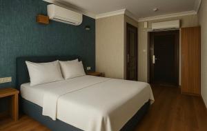 a bedroom with a white bed and a blue wall at Red Green in Izmir