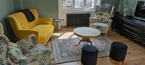 a living room with chairs and a table at Authentique maison Morlaisienne in Morlaix