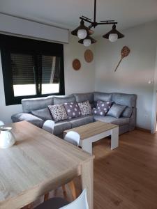 a living room with a couch and a table at A casa da Piruleta in Bueu +23 photos