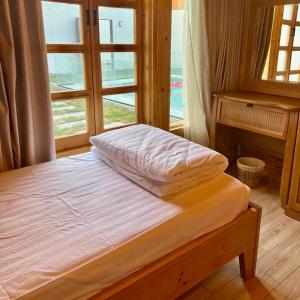 a bed in a room with a large window at أكواخ القرية -VILLAGE HUTs in Taif +43 photos