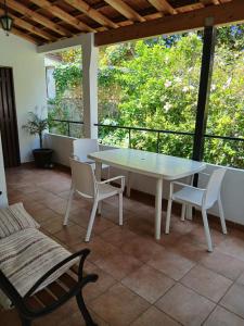 a white table and chairs on a patio with a window at Casa da Nonô in Coimbra