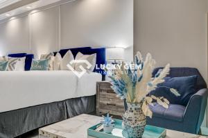 a living room with a couch and a vase with flowers at Lucky Gem Penthouse & Luxury Suites at Signature Resort, Strip View 509 in Las Vegas +41 photos
