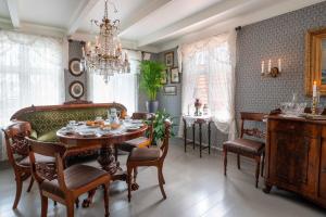 a dining room with a table and chairs and a chandelier at Lundins Hotell in Karmøy