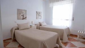 Posteľ alebo postele v izbe v ubytovaní Hostal Jomarijo