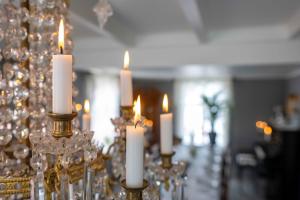 a group of candles sitting on a table in a room at Lundins Hotell in Karmøy