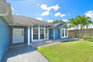 a home with a blue house with a yard at Blue Haven Villa 3 Bedroom 2 Bathroom Home in Port Saint Lucie