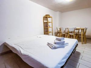 a room with a bed with a table and chairs at Al centro di Gaeta - CasAurora PT in Gaeta