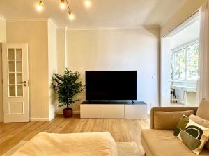 a living room with a large flat screen tv at Charming and peaceful apartment, Cascais center in Cascais