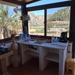 a kitchen with a sink and a window at La Foggia seaside paradise in Siculiana