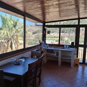 a dining room with a table and some windows at La Foggia seaside paradise in Siculiana