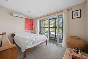 una camera da letto con un letto e una grande finestra di Fremantle Character Cottage a Fremantle