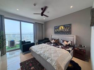 a bedroom with a bed and a ceiling fan at The Twilight Flora in Gurgaon +15 photos