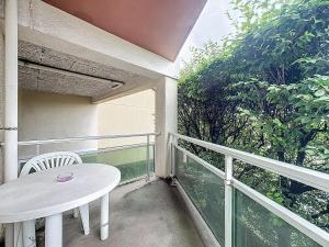 a white table and chair on a balcony at Studio 2 personnes avec parking et balcon Proudhon in Clermont-Ferrand