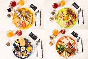 a white table with plates of food and fruit at Hotel Rubens in Rimini