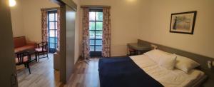 Postel nebo postele na pokoji v ubytování Abbázia Club Hotel Kék