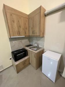 a small kitchen with a sink and a refrigerator at Saranda View Apartments in Sarandë