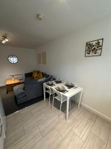 a living room with a couch and a table at Orchard Court Spacious 2 bedroom apartment in Wednesbury
