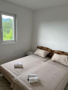 a bedroom with two beds with towels on them at N&D Apartment in Kotor +4 photos