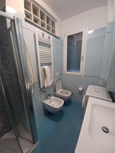 a bathroom with a toilet and a sink and a shower at straccia 2 in Cupra Marittima