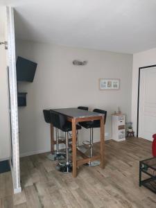 a dining room with a table and black chairs at La Loge du Théâtre in Orange +8 photos