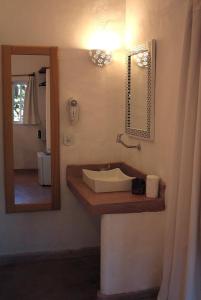 a bathroom with a sink and a mirror at Jardim de Trancoso Pousada in Trancoso