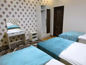 Postel nebo postele na pokoji v ubytování Guest House Ulukbek