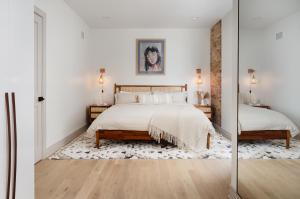 a bedroom with a bed and a mirror at Ace Properties in Chicago