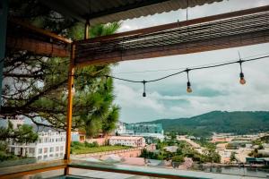 a view of a city from a balcony with lights at Hugo's Family in Da Lat