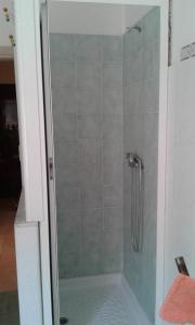 a shower with a glass door in a bathroom at Estrellas De Mar Casa in Giardini Naxos