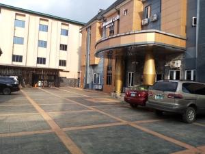 a parking lot with cars parked in front of a building at Diamond castle Hotel in Mama