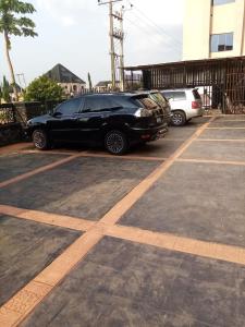 a black car parked in a parking lot at Diamond castle Hotel in Mama +3 photos
