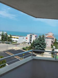 a balcony with a view of a parking lot at Къща за гости Смокиня in Obzor