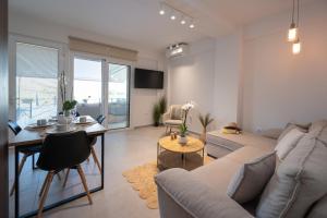 a living room with a couch and a table at Rastoni Luxury Home in Pogoniá