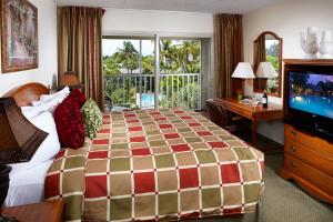 a bedroom with a large bed and a television at Best Western Naples Inn & Suites in Naples +22 photos