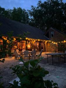 a building with a table and chairs and lights at Bos & Pingo in Kollum