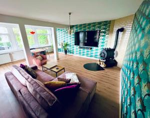 a living room with a couch and a fireplace at Ferienhaus Hugo in Lubmin