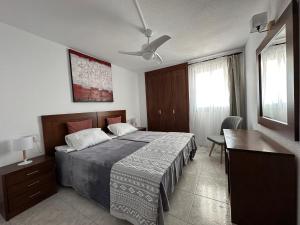 a bedroom with a bed and a table and a desk at BENIDORM SKYLiNE in Benidorm +19 photos