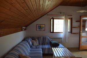 a living room with a couch and a window at Apartments Tonka Grebaštica in Grebaštica