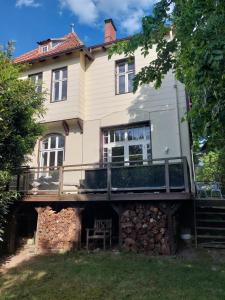 a large house with a deck on the side of it at Villa Elisabeth 1905 in Bad Harzburg