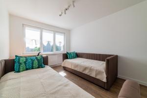 Ένα ή περισσότερα κρεβάτια σε δωμάτιο στο Blue Sky Apartments
