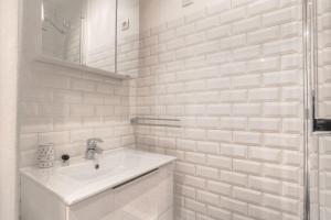 a white bathroom with a sink and a shower at Beautiful bright apartment - Near Fourvière in Lyon