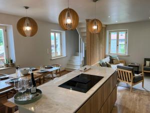 a living room with a kitchen and a living room with a couch at Chalet Tomsine in Samoëns